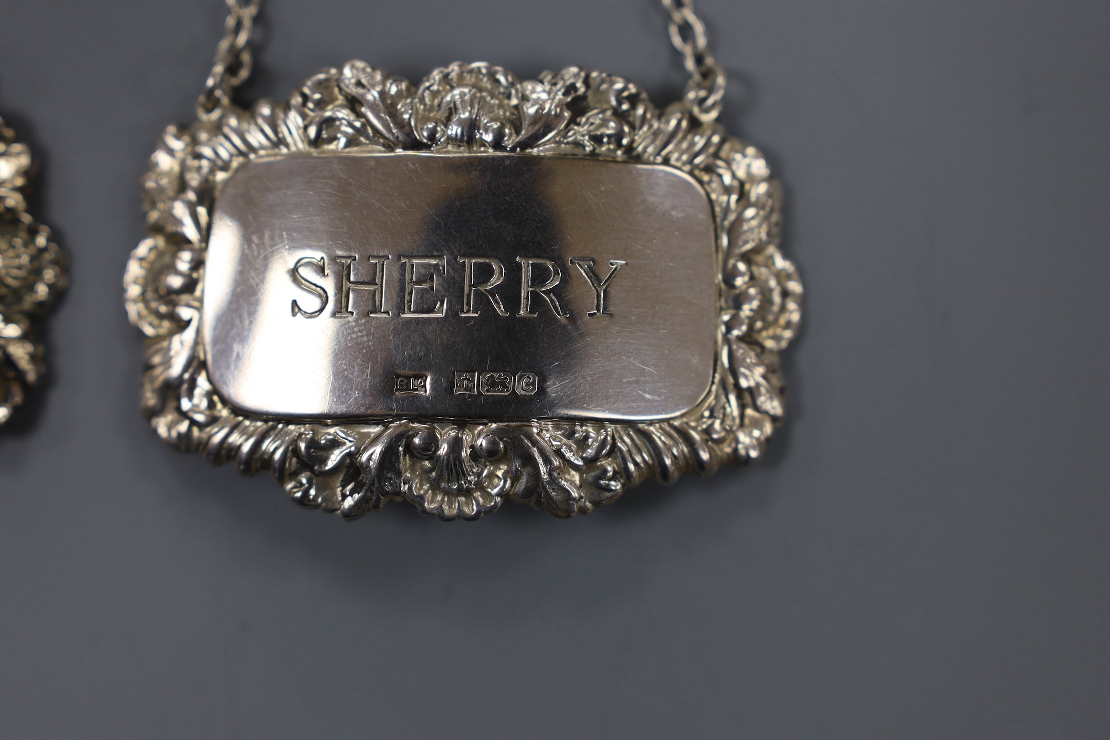 A modern pair of silver 'Sherry' & 'Madeira' wine labels, three other silver 'Sherry' wine labels and a plated wine label.